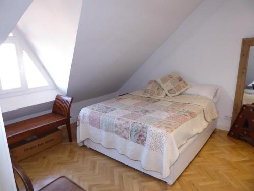 a bedroom with a bed and a chair and a window at Apartamento en el Mercado de San Miguel in Madrid