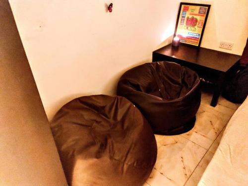 two brown bean bags sitting on the floor in a room at Full Apartment in Central Al Ain (All Amenities) in Al Ain