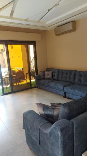 a living room with couches and a couch and a table at Villa Jana chalet - Private Villa - Dead Sea - Jordan in Ash Shāghūr
