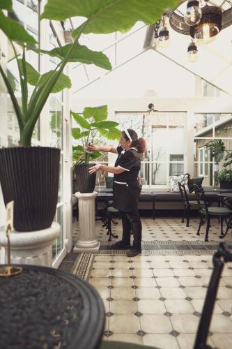 a woman standing in a room with a plant at Vinnhaus in Puerto Natales
