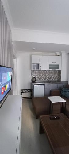 a living room with a couch and a flat screen tv at Maxx Marine in Konak
