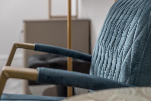a close up of the back of a blue chair at Hotel Vila Central Boutique Satu Mare in Satu Mare