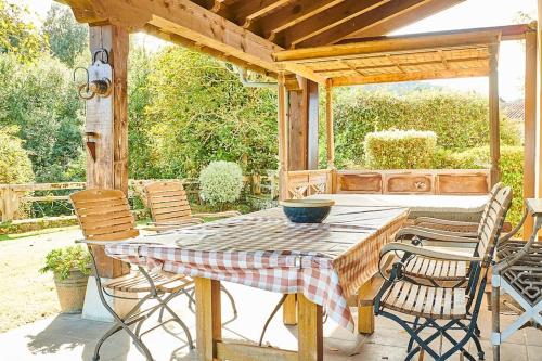 a wooden table and chairs on a patio at Casa rural en plena naturaleza, playa, senderismo in Villahormes
