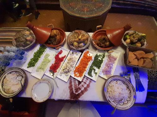 a table topped with lots of different types of food at Dar Merzouga Meknes in Meknès