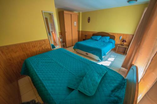 an overhead view of a bedroom with two beds at Hotel Montecarlo in Caldera