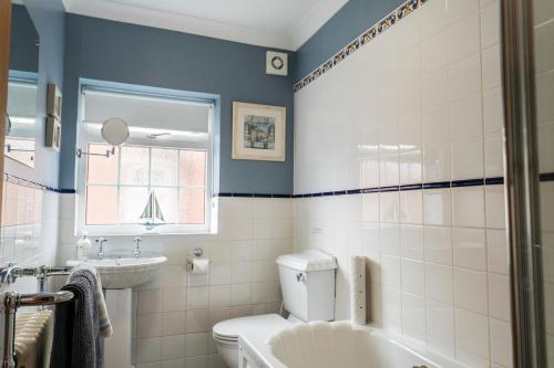 a bathroom with a white toilet and a sink at Corner Cottage - character, charm, great location. in Ringwood
