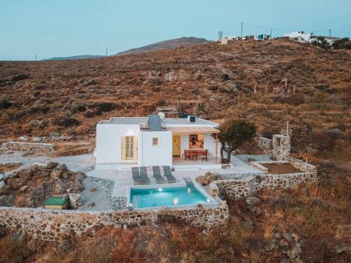 a villa with a swimming pool on a hill at Livas Residence in Megálon Khoríon