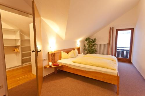 a bedroom with a large bed and a window at Familien- und Wellnesshotel "Viktoria" in Oberstdorf