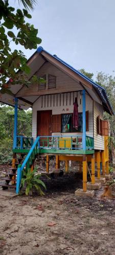 a small house with a large deck in front of it at Baan Suan Kayoo 2 Buffalo Bay Aow Khao Kwai in Ko Phayam