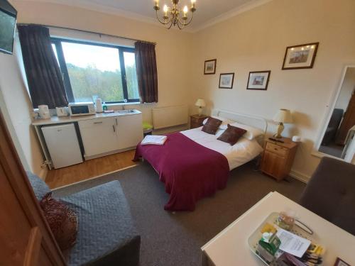 a bedroom with a bed and a large window at Sergeants Accommodation in Nelson