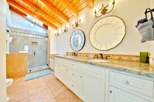 a bathroom with a sink and a toilet and a mirror at Cliff Dr View in Laguna Beach