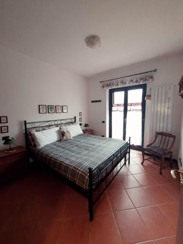 a bedroom with a bed and a chair at Le Casette d'Abruzzo in Ateleta