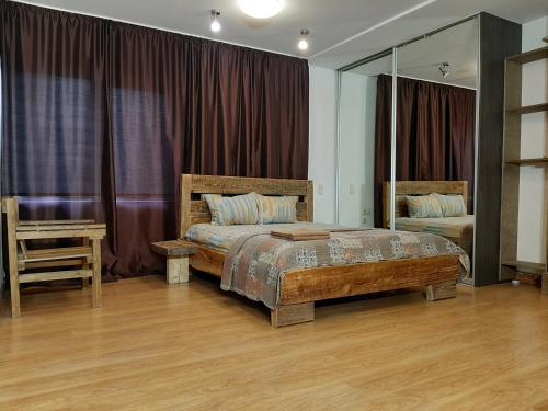 a bedroom with a bed and a table and a mirror at AVIATRIX Night Airport Haven in Rīga