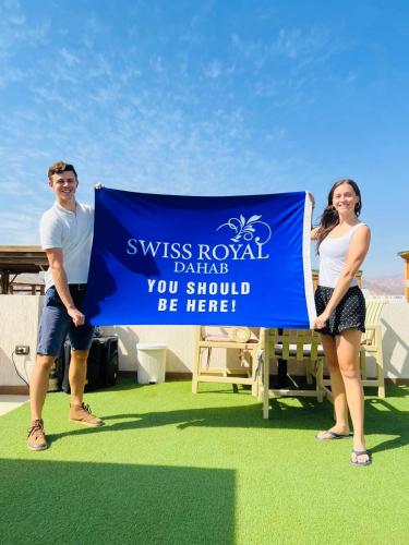 a man and a woman standing next to a sign at Swiss Royal DAHAB in Dahab