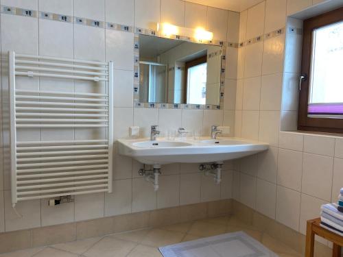 a bathroom with a sink and a mirror at Ferienwohnungen Hinteranger in Tux
