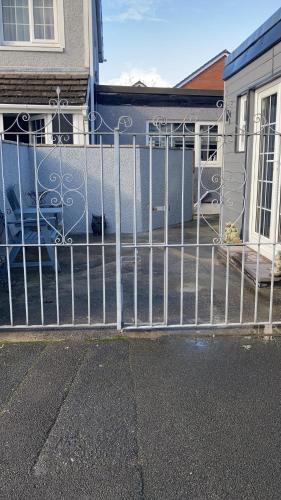 a metal fence in front of a house at Roblins Nest in Ammanford