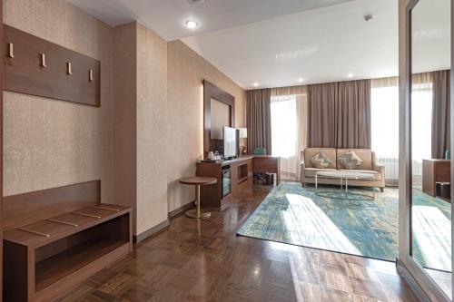 a hotel room with a lobby with a living room at Best Western Plus Astana Hotel in Astana