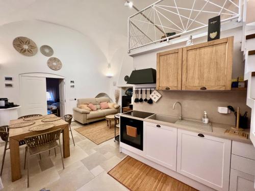 a kitchen and a living room with a table at Al Bastione del Borgo Saraceno, Varigotti in Varigotti