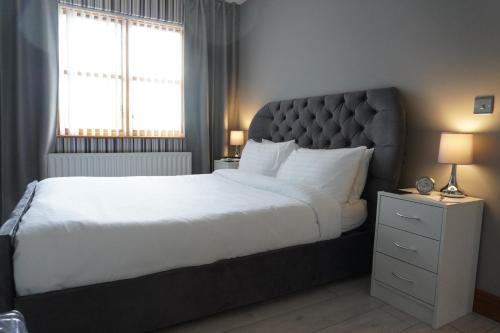 een slaapkamer met een groot bed en een raam bij VIP@TheMeadows in Portadown