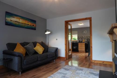 a living room with a couch and a kitchen at VIP@TheMeadows in Portadown