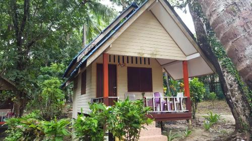 a small house in the middle of a forest at Baan Suan Kayoo 2 Buffalo Bay Aow Khao Kwai in Ko Phayam