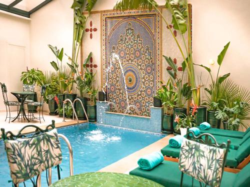 a pool in a room with a tapestry at Hotel Safia in Marrakesh