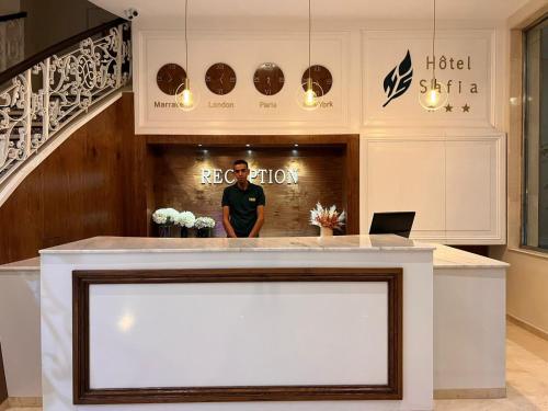 a man standing behind a counter in a hotel salon at Hotel Safia in Marrakech