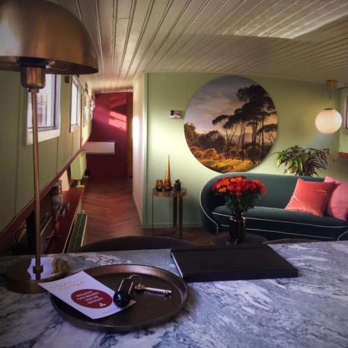 a living room with a sink and a couch at Houseboat 'Boat Boutique' in Zwolle