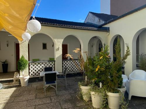 a patio with chairs and plants in front of a building at Hotel Michael in Gerasdorf bei Wien