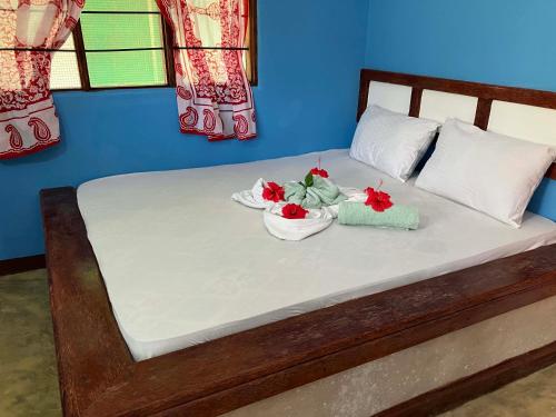 a bed with two bowls of flowers on it at Mount Zion Lodge in Michamvi