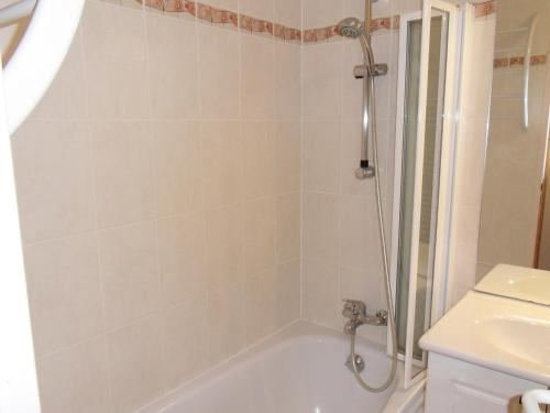 une salle de bain avec douche et baignoire dans l'établissement Appartement cosy au pied des pistes avec balcon et parking - FR-1-181-2040, à La Plagne Tarentaise