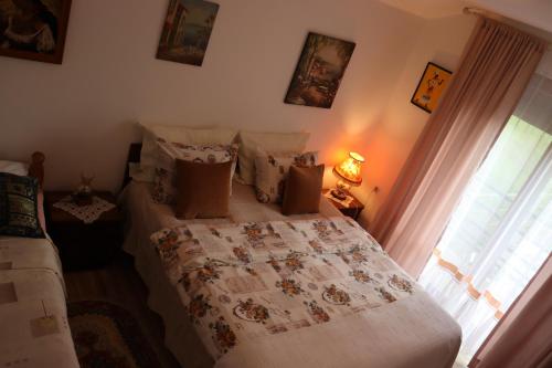 a bedroom with a bed and a window at Frile Apartments in Nikšić