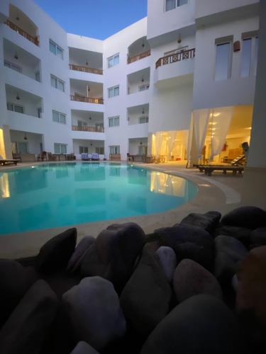 a large swimming pool in front of a building at Blue Vision Diving Hotel in Marsa Alam City