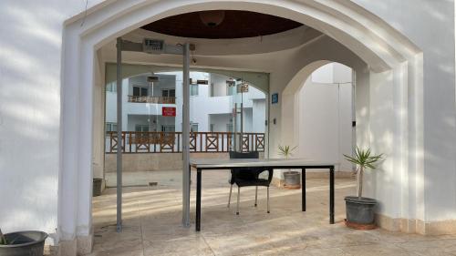 an archway with a table in the middle of a building at Blue Vision Diving Hotel in Marsa Alam City