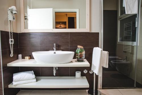 a bathroom with a sink and a mirror at Hotel Universal in Senigallia