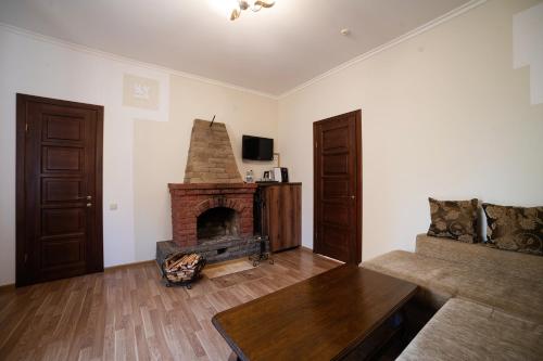 a living room with a fireplace and a couch at Рестпарк рекреаційний комплекс in Luts'k