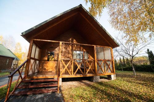 a small log cabin with a steep roof at Рестпарк рекреаційний комплекс in Luts'k