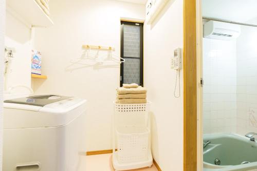 a small bathroom with a toilet and a sink at Luxury Guest House in Tokyo Shinjuku in Tokyo