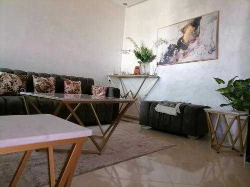 ein Wohnzimmer mit einem Sofa und einem Tisch in der Unterkunft Aswa9 salam in Kenitra