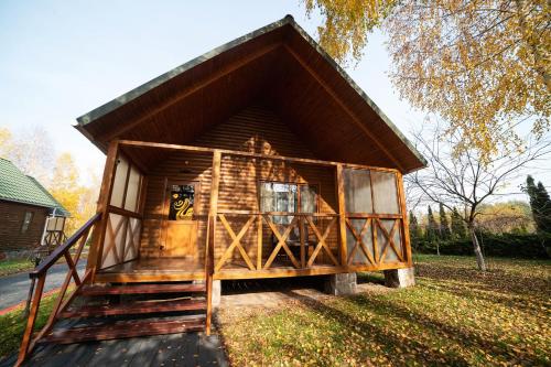 a small log cabin with a steep roof at Рестпарк рекреаційний комплекс in Luts'k