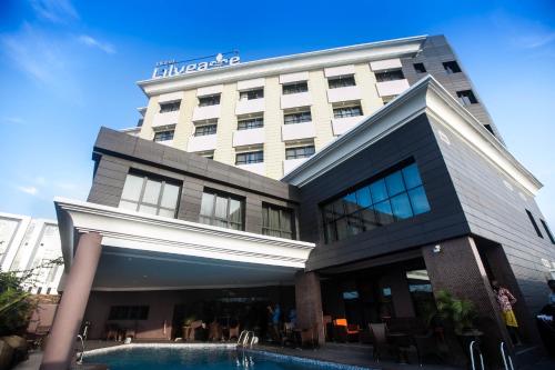 a hotel with a swimming pool in front of it at The Lilygate Lagos in Lagos
