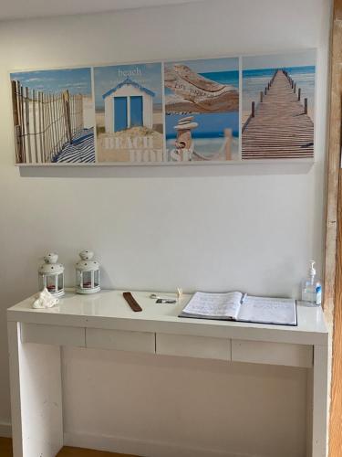 a white desk with pictures on the wall at Hostel Eleven in Esposende