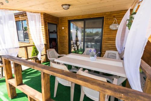 a table and chairs on the porch of a house at ECO Hоuses - Camping Gradina in Chernomorets
