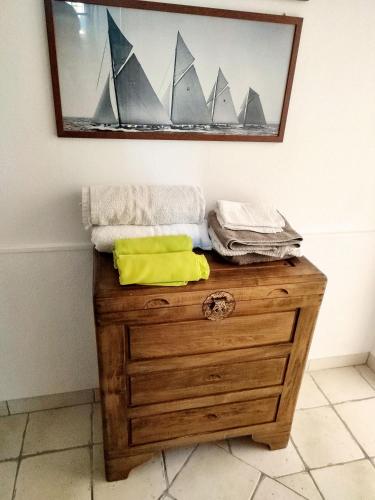 a wooden dresser with a picture of boats on it at Casa Patrizia in Olbia