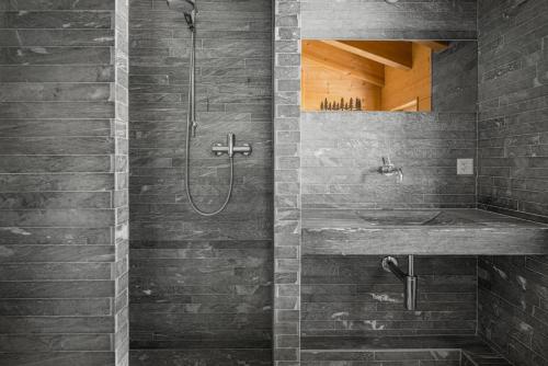 a bathroom with a shower and a sink at Rupicapra in Bettmeralp