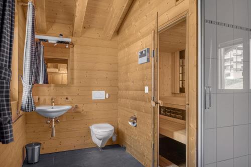 a small bathroom with a toilet and a sink at Laackerhof in Bettmeralp