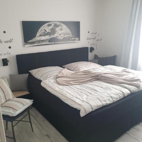 a bedroom with a large bed with a moon on the wall at Haus KanaleGrande in Haltern