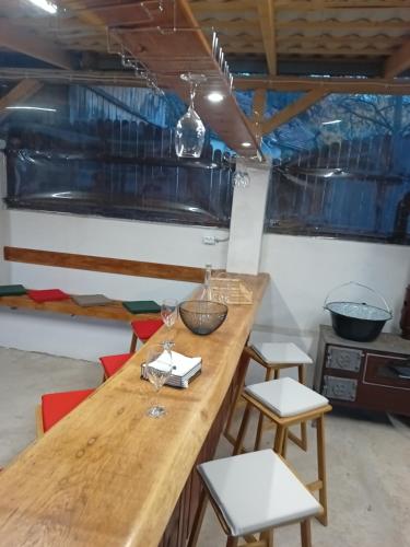 a kitchen with a wooden table and stools at MONADIN Villa Relax & Spa in Săcele