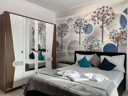 a bedroom with a bed with blue and white at GLAM Apartments Palas Mall Center Area in Iaşi