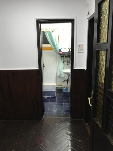 an open door to a bathroom with a sink at Salaš Striber in Vrbas